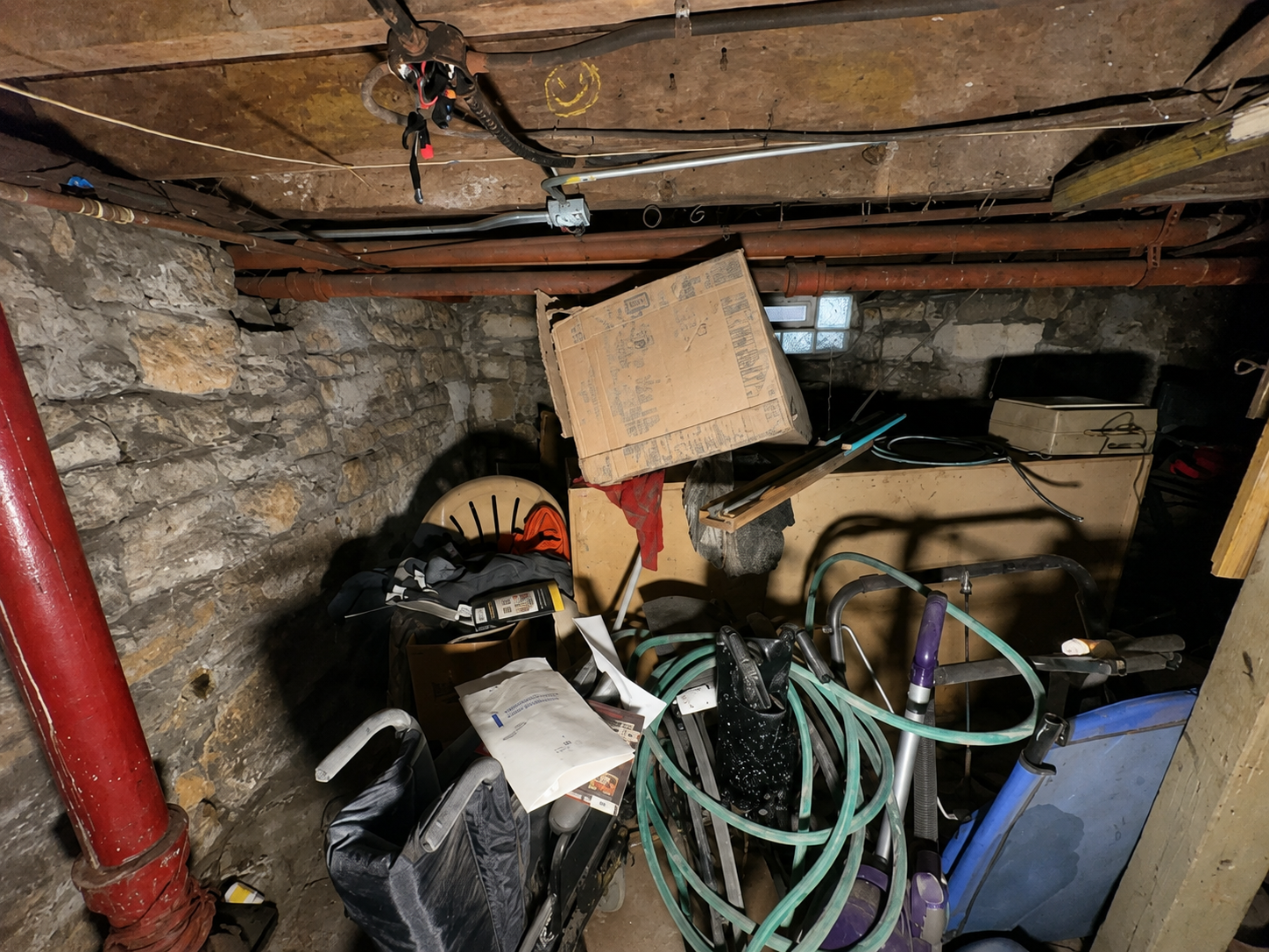 Basement before cleanout — cluttered with furniture and boxes